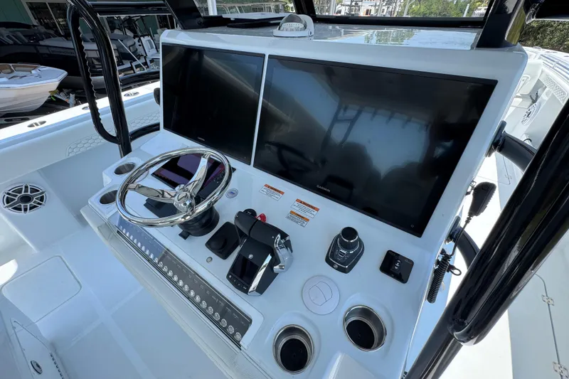 Slide: The Image of Helm of 2026 Invincible 46 Catamaran with dual screens and modern controls. - 34