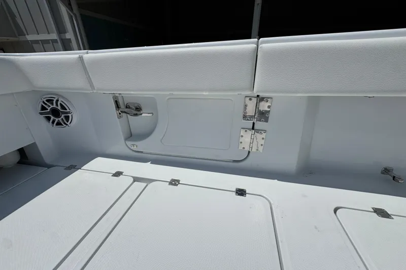 Slide: The Image of Interior view of 2026 Invincible 46 Catamaran, featuring sleek white seating and storage compartments. - 42