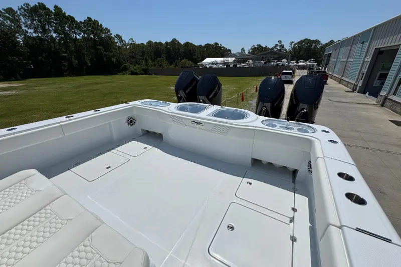 Slide: The Image of 2026 Invincible 46 Catamaran with powerful engines docked near a marina. - 43