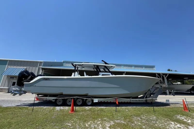 Slide: The Image of 2026 Invincible 46 Catamaran on trailer under clear blue sky. - 7