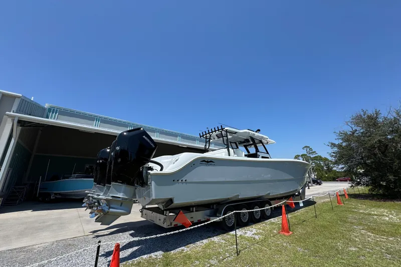 Slide: The Image of 2026 Invincible 46 Catamaran on trailer, parked outdoors under clear blue sky. - 9