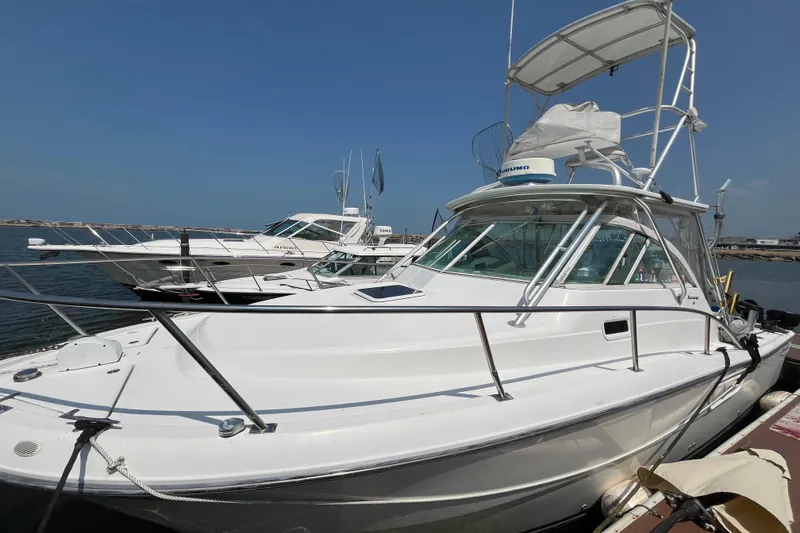 The Image of 2001 Rampage Express 30 Open boat docked at marina under clear blue sky. - 0