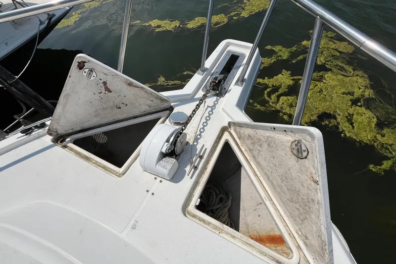 Slide: The Image of Bow of 2001 Rampage Express 30 Open with anchor chain and storage compartments. - 11