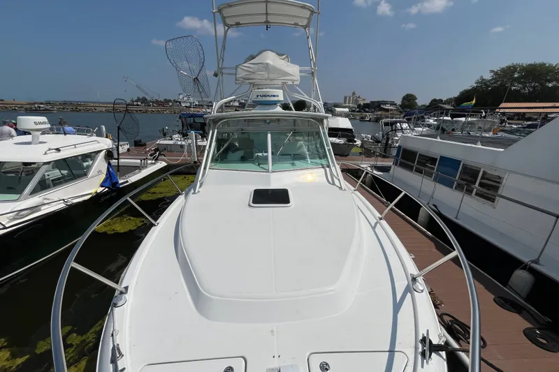 Slide: The Image of 2001 Rampage Express 30 Open boat docked at marina, surrounded by other vessels. - 12