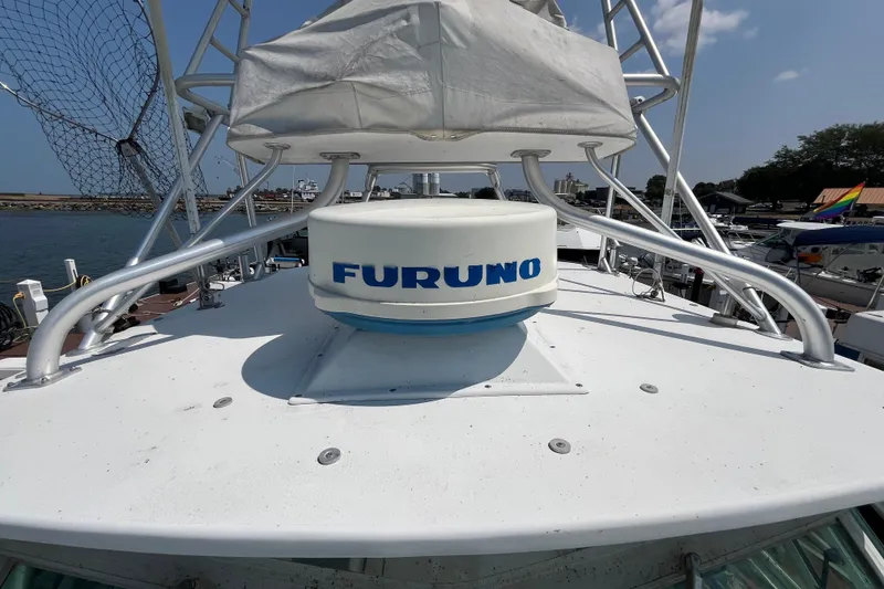 Slide: The Image of 2001 Rampage Express 30 Open boat with Furuno radar, docked at marina. - 13