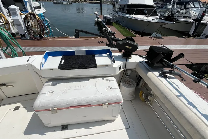 Slide: The Image of 2001 Rampage Express 30 Open boat with fishing gear and cooler at marina dock. - 15
