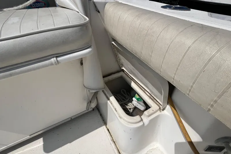 Slide: The Image of 2001 Rampage Express 30 Open boat interior with storage compartment and seating. - 18