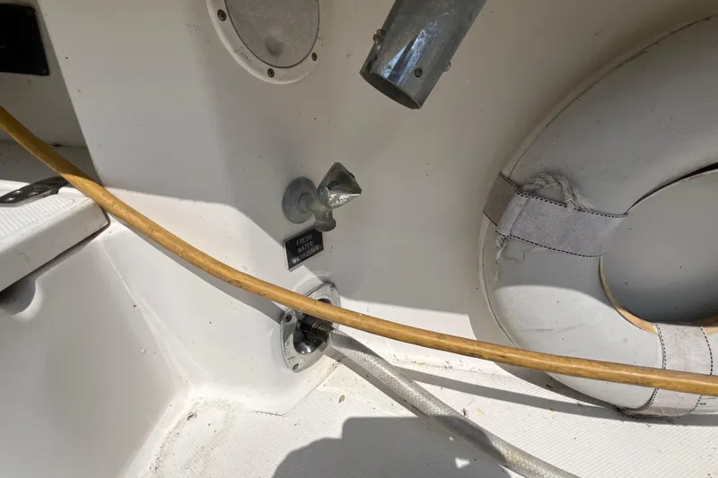 Slide: The Image of 2001 Rampage Express 30 Open boat interior with hose and life preserver. - 20