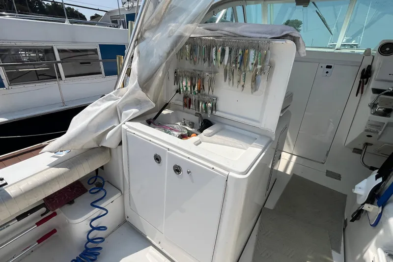 Slide: The Image of 2001 Rampage Express 30 Open boat interior with fishing gear and tackle storage. - 23