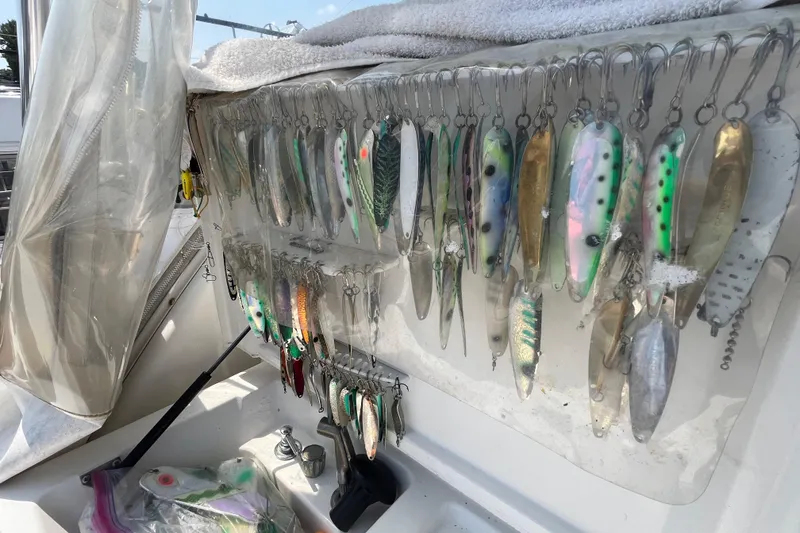 Slide: The Image of Fishing lures displayed on a 2001 Rampage Express 30 Open boat. - 25