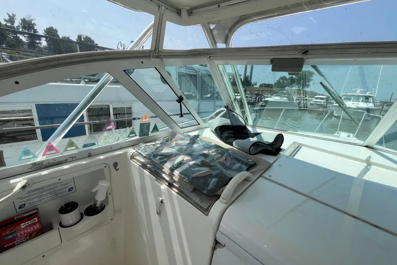 Slide: The Image of 2001 Rampage Express 30 Open boat interior with fishing gear and marina view. - 35
