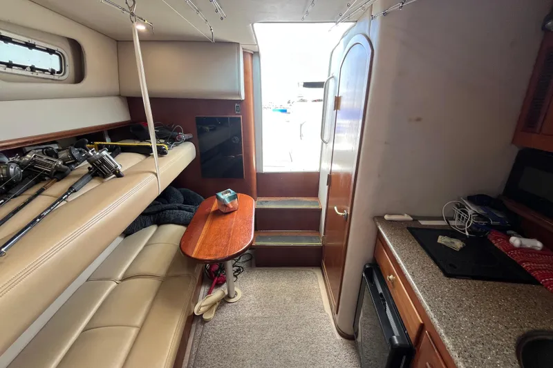 Slide: The Image of Interior of 2001 Rampage Express 30 Open boat with fishing rods and kitchenette. - 39