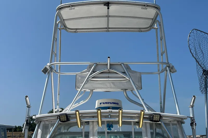 Slide: The Image of 2001 Rampage Express 30 Open boat with tower and fishing equipment against clear sky. - 4