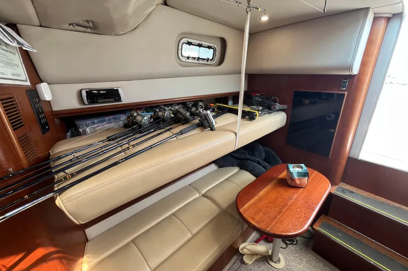 Slide: The Image of Interior of 2001 Rampage Express 30 Open with fishing rods and cozy seating area. - 40