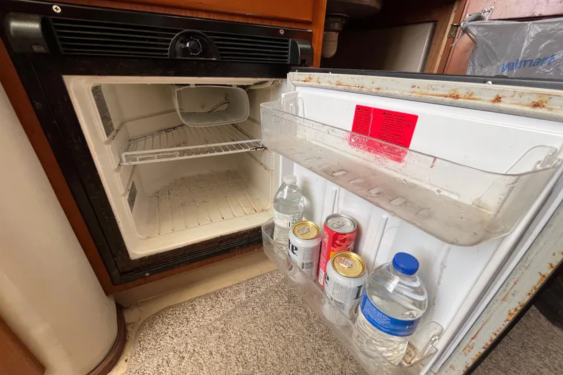 Slide: The Image of Open mini fridge on 2001 Rampage Express 30 Open boat, stocked with drinks. - 43