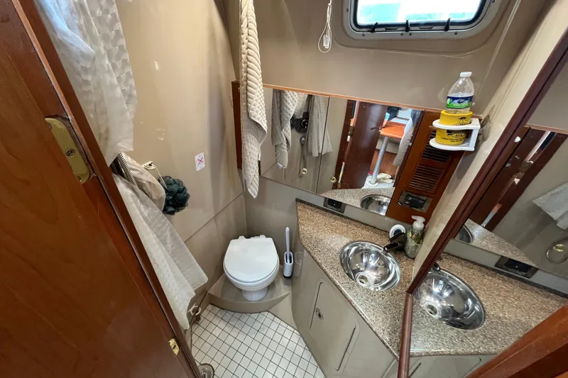 Slide: The Image of Bathroom interior of 2001 Rampage Express 30 Open boat, featuring sink and toilet. - 49