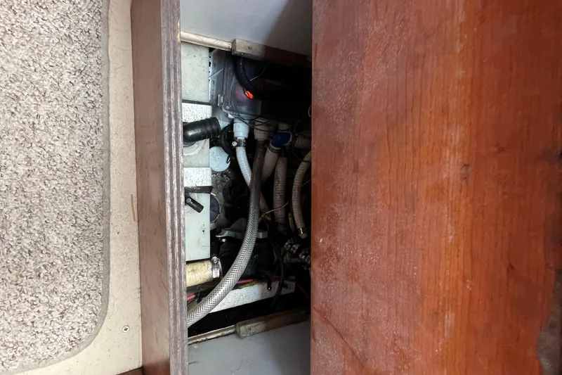 Slide: The Image of Engine compartment of 2001 Rampage Express 30 Open boat, showing hoses and components. - 52