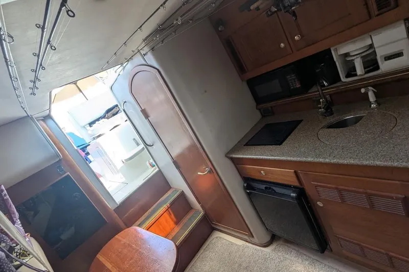 Slide: The Image of 2001 Rampage Express 30 Open boat interior with kitchenette and seating area. - 55