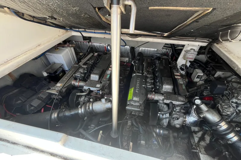 Slide: The Image of Engine compartment of a 2001 Rampage Express 30 Open boat, showcasing dual engines. - 59