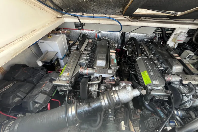 Slide: The Image of Engine compartment of a 2001 Rampage Express 30 Open boat, showcasing dual engines. - 62
