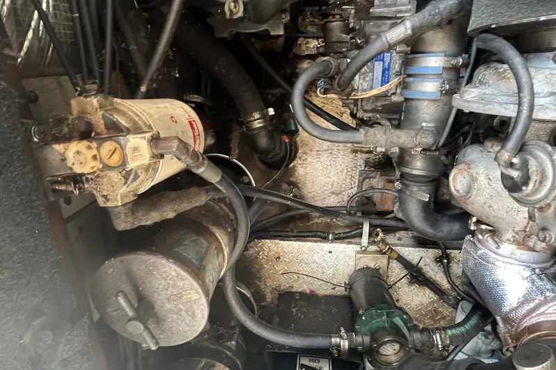 Slide: The Image of Engine compartment of a 2001 Rampage Express 30 Open boat, showing various mechanical components. - 63