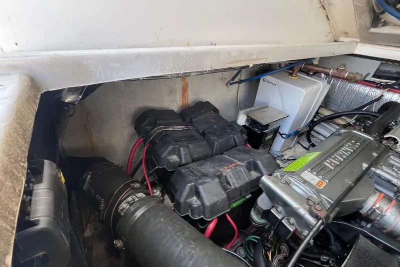 Slide: The Image of Engine compartment of 2001 Rampage Express 30 Open with batteries and wiring. - 64