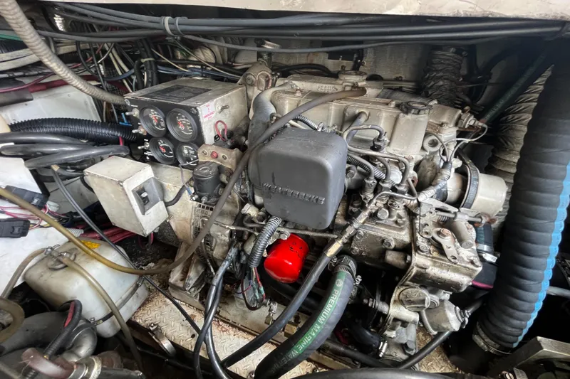 Slide: The Image of Engine compartment of a 2001 Rampage Express 30 Open boat, showcasing detailed machinery. - 65