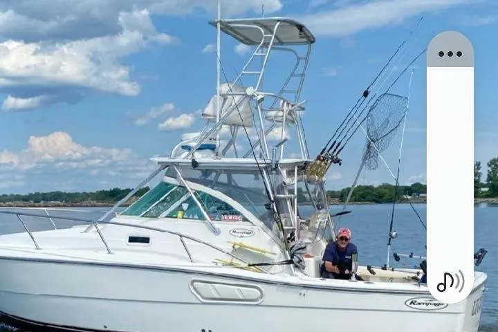 Slide: The Image of 2001 Rampage Express 30 Open boat on water, equipped for fishing, under a clear sky. - 67