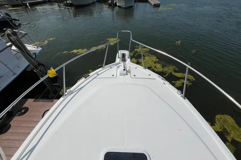 Slide: The Image of Bow view of a 2001 Rampage Express 30 Open boat docked in a marina. - 9