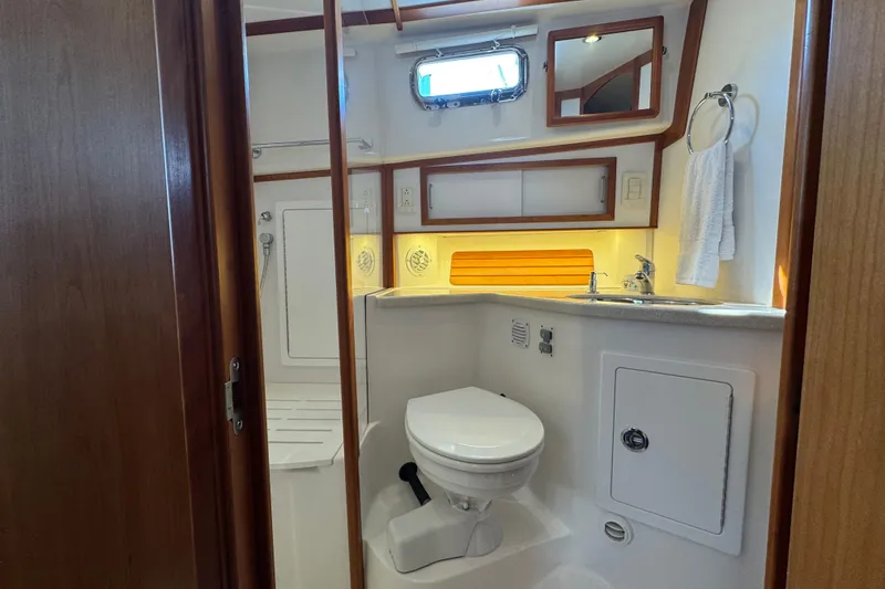 Slide: The Image of 2016 Sabre Craft Salon Express bathroom with toilet, sink, and wooden accents. - 16