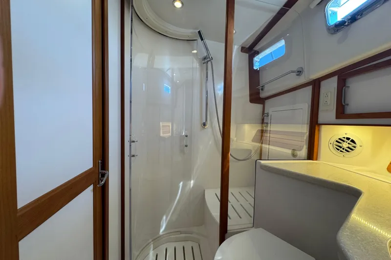 Slide: The Image of 2016 Sabre Craft Salon Express bathroom with shower, wooden accents, and modern fixtures. - 17