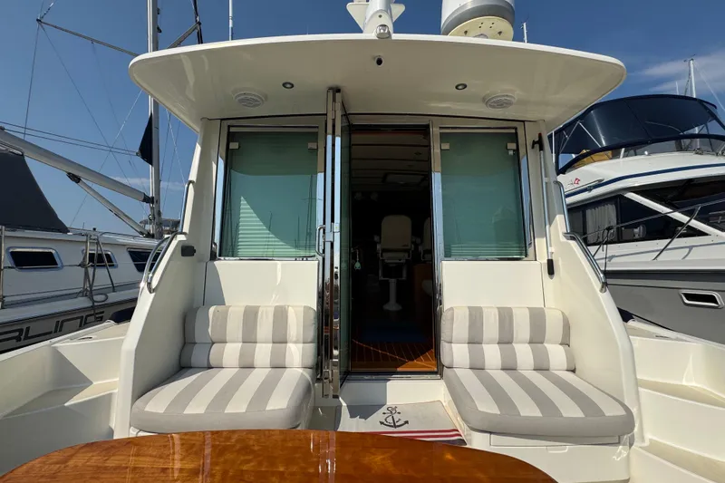 Slide: The Image of 2016 Sabre Craft Salon Express yacht with striped seating and open cabin doors. - 19