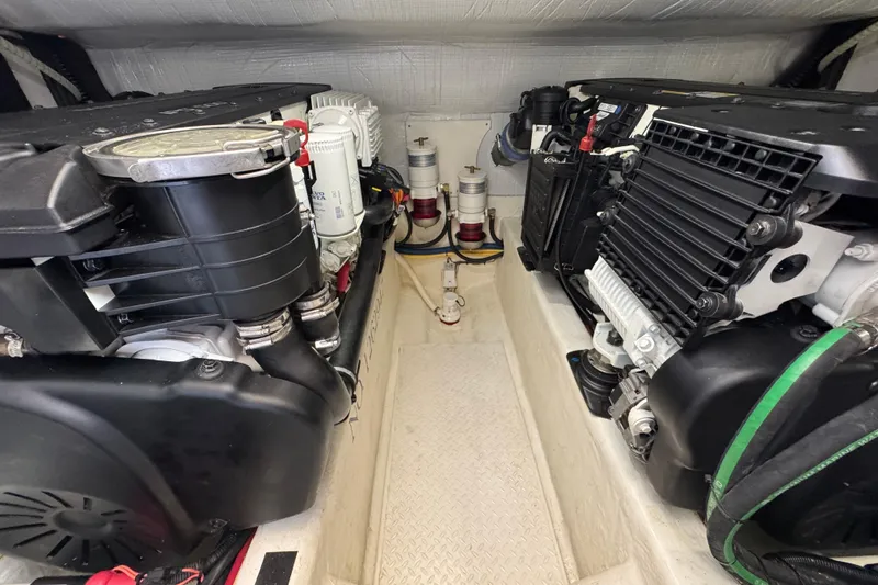 Slide: The Image of Engine room of 2016 Sabre Craft Salon Express, showcasing dual engines and components. - 34