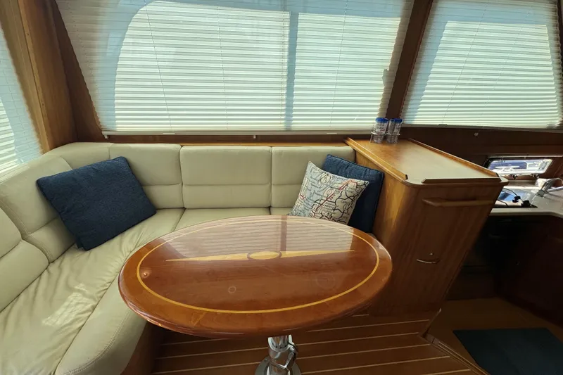 Slide: The Image of Interior of 2016 Sabre Craft Salon Express with cozy seating and wooden table. - 6