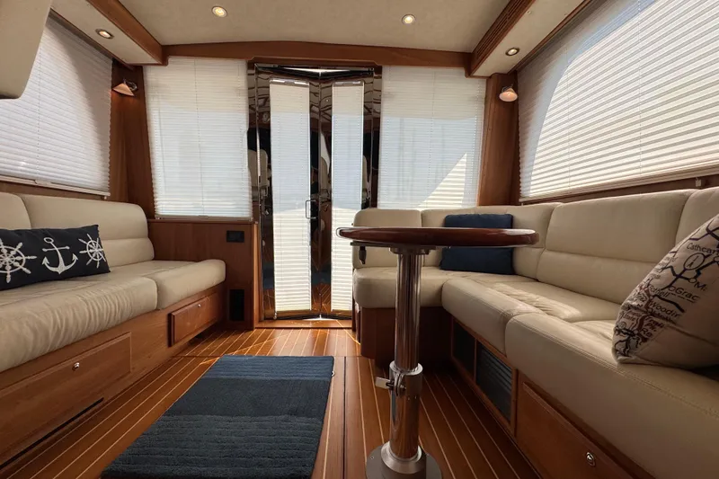 Slide: The Image of Luxurious 2016 Sabre Craft Salon Express interior with elegant seating and nautical decor. - 7