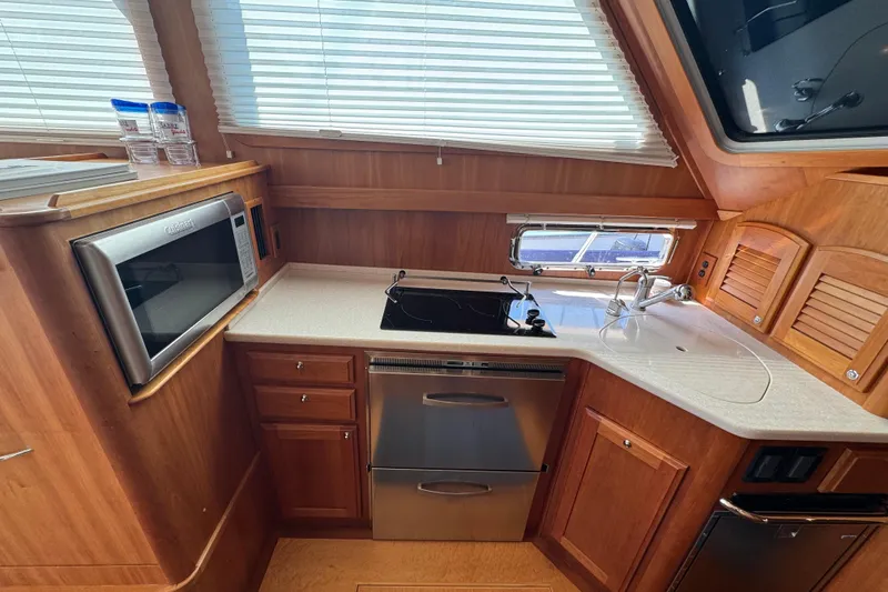 Slide: The Image of 2016 Sabre Craft Salon Express kitchen with microwave, stove, and sink. - 9