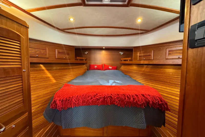 Slide: The Image of 2016 Sabre Craft Salon Express cabin with cozy bed, wooden interior, and ambient lighting. - 14