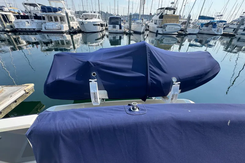 Slide: The Image of 2016 Sabre Craft Salon Express at marina, covered with blue fabric, surrounded by boats. - 24