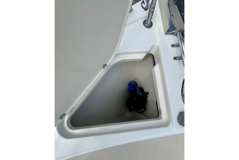 Slide: The Image of Open storage compartment on 2016 Sabre Craft Salon Express boat deck. - 31