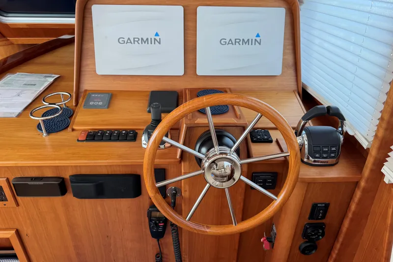 Slide: The Image of 2016 Sabre Craft Salon Express helm with Garmin displays and wooden steering wheel. - 5