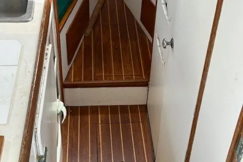 Slide: The Image of 1960 Dyer Hard Top boat interior with wooden flooring and white cabinetry. - 12