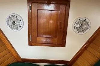 Slide: The Image of 1960 Dyer Hard Top interior with wooden paneling and round speakers. - 18