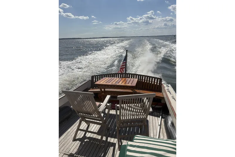 Slide: The Image of 1960 Dyer Hard Top boat with flush deck, cruising on open water under a sunny sky. - 21