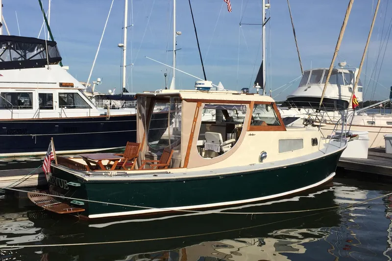 Slide: The Image of 1960 Dyer Hard Top boat with flush deck, docked in a marina. - 4