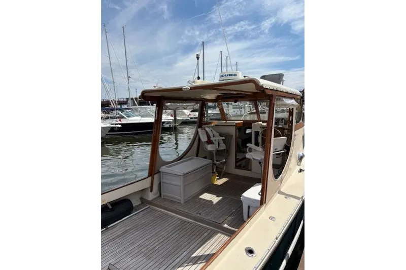 Slide: The Image of 1960 Dyer Hard Top boat with flush deck, docked at marina under blue sky. - 6