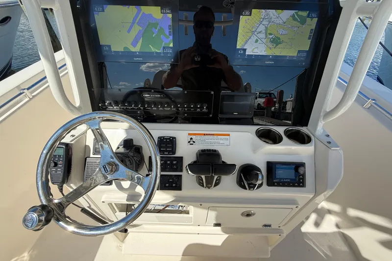 Slide: The Image of 2023 Cobia 280 Center Console helm with navigation screens and controls. - 19
