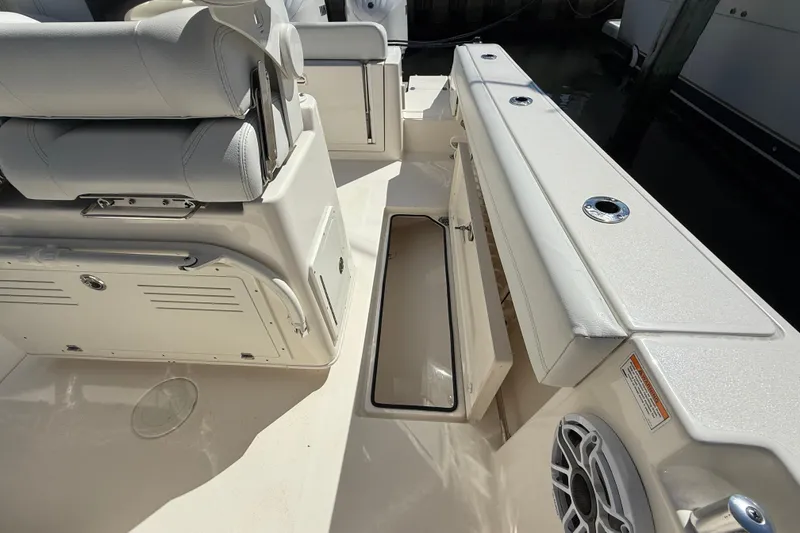 Slide: The Image of 2023 Cobia 280 Center Console boat interior with storage compartment and seating. - 27
