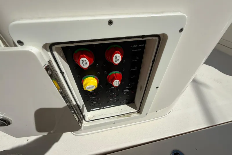 Slide: The Image of Control panel on a 2023 Cobia 280 Center Console boat, featuring labeled switches. - 29