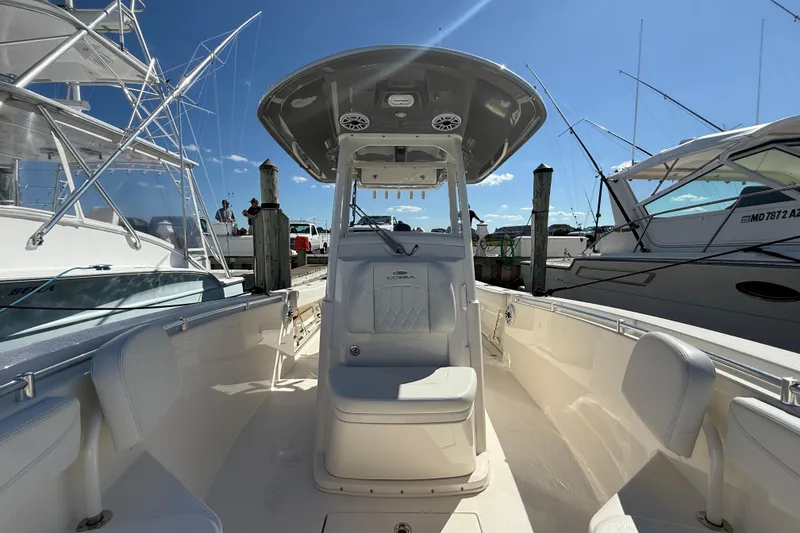 Slide: The Image of 2023 Cobia 280 Center Console boat docked under clear blue sky. - 32