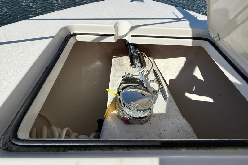 Slide: The Image of Anchor compartment of 2023 Cobia 280 Center Console boat, open hatch view. - 40